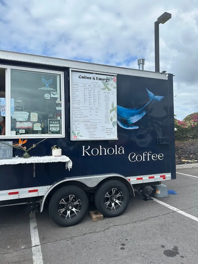 Navy Kohola Coffee trailer in a parking lot, with a service window, menu board, and whale graphic.