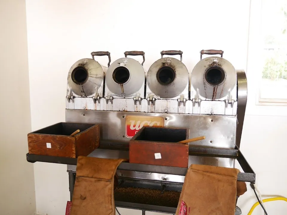 A row of four small sample roasters in the UCC Hawaii roasting room.