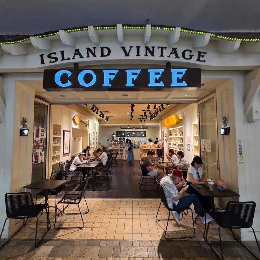 Island Vintage Coffee storefront, with people seated at tables and standing inside.