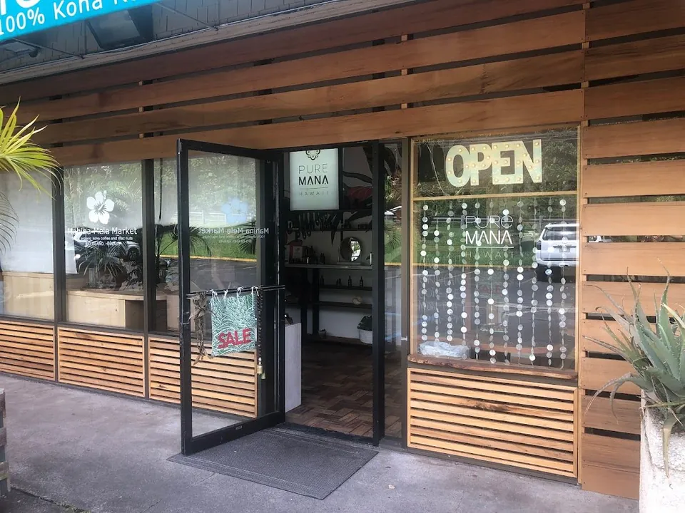Wood storefront of Mahina Mele Market with an open door, OPEN and SALE signs, and Pure Mana Hawaii lettering.