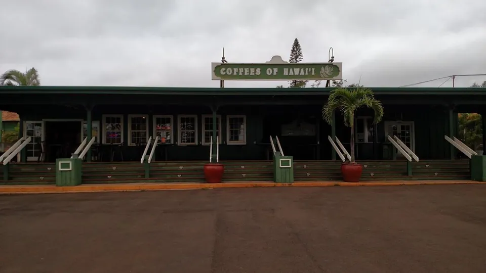 Dark green storefront with a covered porch and a sign reading COFFEES OF HAWAI'I.