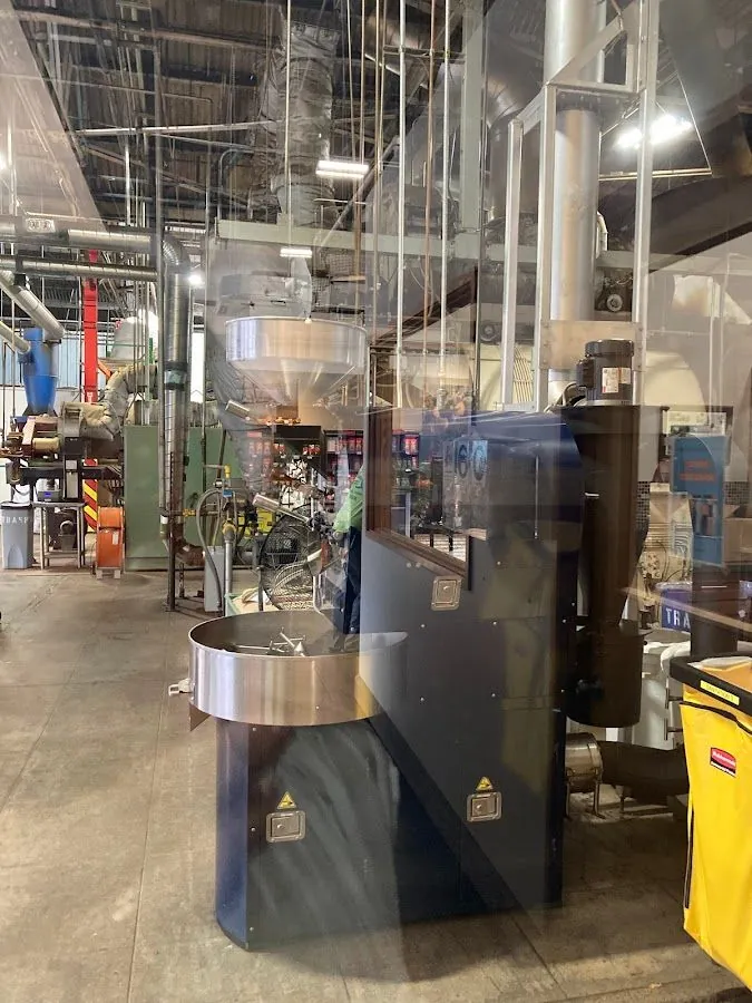 Roasting machines and steel bins on the Lion Coffee roastery floor.