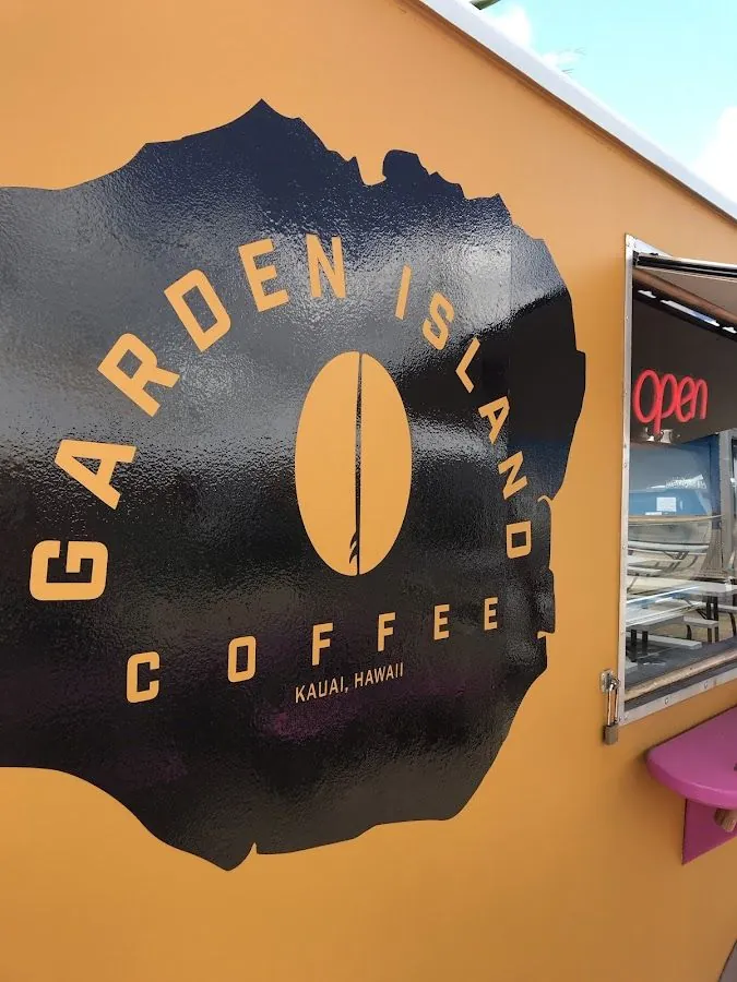 Mustard-yellow vehicle side with a black island-shaped Garden Island Coffee logo and a red open sign in the window.